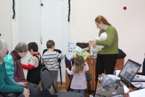 Valya, the children's ministry director, passing out gifts to the kids